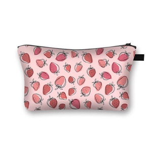 Pink cosmetic bag with strawberry print and black zipper on a clean white background