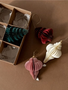 Detail of paper honeycomb Christmas ornaments with gold edges and tassel accents
