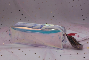 Macro shot of iridescent laser pencil case with colorful tassel zipper and shiny PVC material