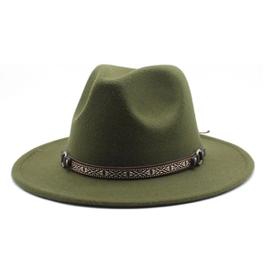 Detail of olive green wool fedora hat featuring ethnic woven band and metal buckle accents