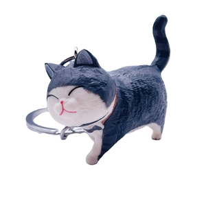 Cute black and white cartoon cat keychain with silver metal ring on white background