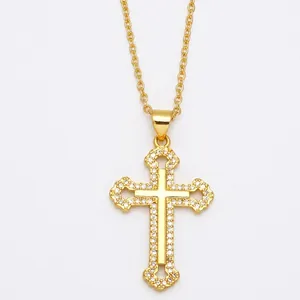 Vintage gold cross pendant necklace with sparkling zircon crystals on white background