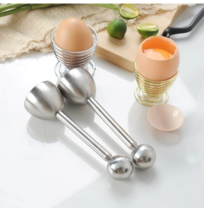 Macro view of stainless steel egg opener set with silver and gold spring wire egg holders