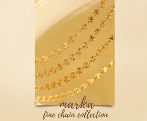 Macro shot of gold serrated wave-textured coin charm bracelet with 18K plating