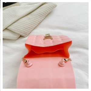 Detail view of pink quilted jelly bag showing internal structure and golden metal lock