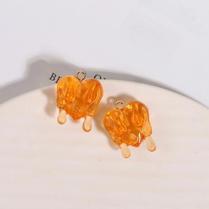Translucent orange resin heart pendant with melting drop effect and gold metal ring