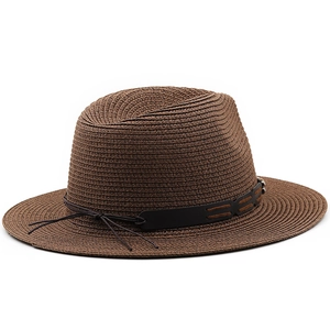 Detail of dark brown straw fedora featuring a black leather band and woven texture