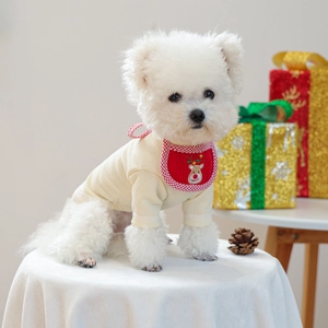 Detail of knitted beige pet sweater and festive red reindeer embroidered bandana set