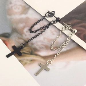 Detail of black and silver punk cross stud earrings with long metal chains