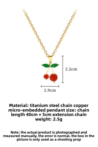Detail of red cherry pendant with micro-set crystals and gold titanium steel chain