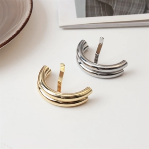 Close-up of gold and silver lava texture hair clips with mirror finish and curved hooks