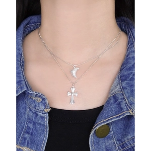 Double-layered S925 sterling silver cross and crescent necklace on a female model