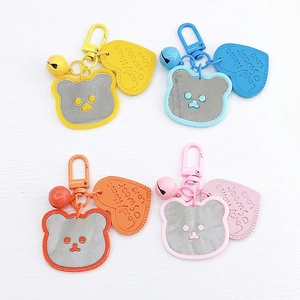 Detailed view of colorful bear mirror keychains with heart charms and small bells