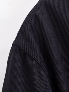 Detail of black twill denim fabric texture with professional reinforced stitching work