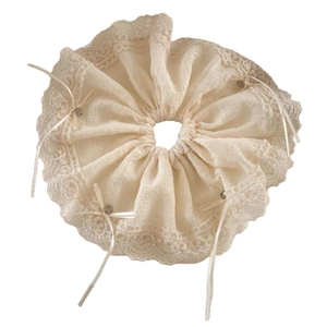 Lace ruffle scrunchie in cream white featuring ribbon bow and bead charm accents