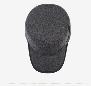 Top-down view of a dark grey men's thermal flat cap with textured warm fabric and sport label