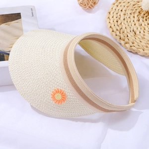 Detail of a beige woven visor featuring a cute daisy and stripe trim for girls