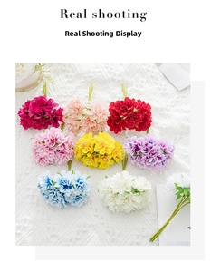 Flat lay of artificial silk flower bouquets in multiple colors on a white lace tablecloth