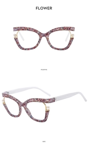 Cat eye glasses frame detail featuring floral patterns and white pearl embellishments