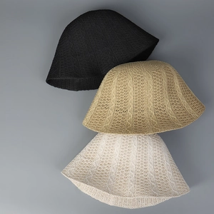 Vertical display of knitted bucket hats in black, khaki, and cream with textured patterns