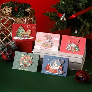 Five assorted 3D pop-up Christmas cards with festive illustrations on a decorative display