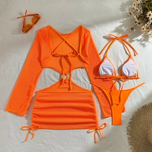 Flat lay of bright orange three-piece bikini set with mesh cover-up and rib knit texture