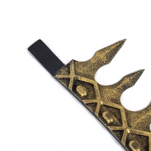 Detail of medieval gold crown showing vintage texture and black elastic band