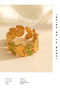 Detail of golden laurel leaf ring with green enamel finish and adjustable open band