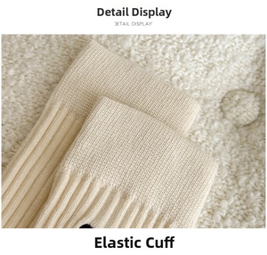 Detailed close-up of cream knit socks featuring elastic ribbed cuffs and bow embroidery