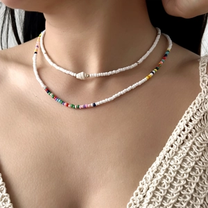 Gros plan d'un collier double épaisseur en perles avec pendentif étoile de mer
