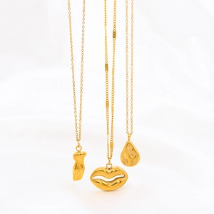 Three gold stainless steel art pendants featuring body, lips and drop shapes on chains