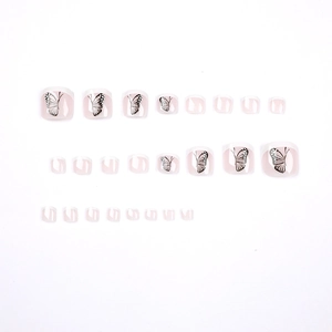 French tip toe press-on nails with elegant black butterfly designs on a white base