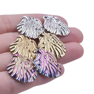 Detail of 304 stainless steel shell stud earrings in silver, gold and rainbow finishes