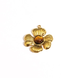 Macro detail of a gold teardrop petal pendant with a brown opal center and sparkling diamonds