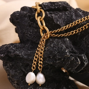Detail of 18K gold plated layered chain necklace with white freshwater baroque pearls