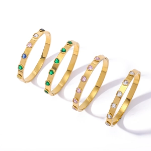 Gold stainless steel bangle set featuring colorful heart-shaped zircon stones on white
