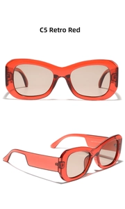 Detail of retro red oversized sunglasses with transparent frames and brown lenses