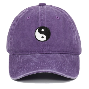 Detailed embroidery of black and white Tai Chi symbol on purple washed cotton baseball cap