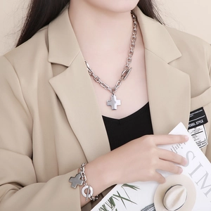 Detail of silver stainless steel cross necklace and bracelet set with OT toggle clasp