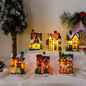 Detailed set of six glowing resin Christmas miniature houses with warm LED lights and snow effects