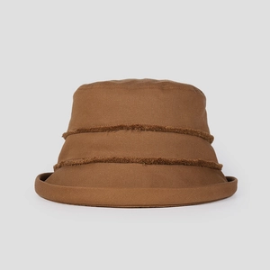 Detail of a brown cotton bucket hat featuring unique frayed decorative fringes and rolled brim