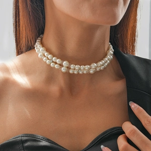 Close-up of elegant double-layer pearl choker necklace with crystal spacers on a model