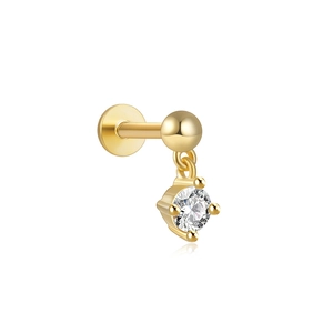Close-up of golden flat back cartilage stud with a round clear gemstone in four-prong setting