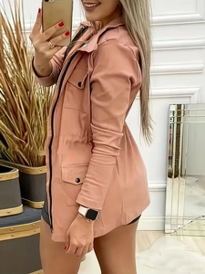 Detail of pink hooded utility jacket featuring adjustable waist drawstring and black buttons