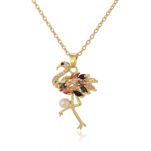 Detailed shot of golden flamingo necklace featuring multi-color crystals and white pearl