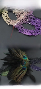 Detail of lace masquerade masks with gradient rhinestones and detachable peacock feathers