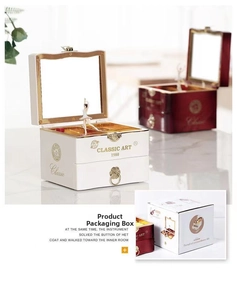 Detail of music box with spinning ballerina, mirror inside, and matching gift box packaging