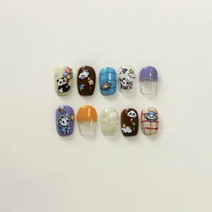 Detailed view of handmade panda and space-themed press-on nails with colorful 3D patterns