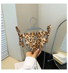 Detailed view of leopard print bikini bag with butterfly charm on a mini hanger