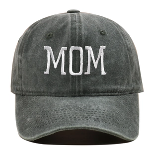 Detail of MOM embroidery on dark grey washed cotton baseball cap with vintage texture
